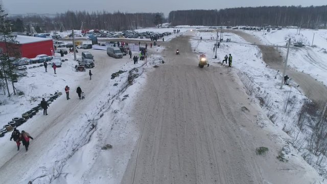 Russia, Championship on snowmobiles January 27, 2018: Winter racing on snowmobiles. Aerial view: Snowmobile on the route in a jump. Action from snowmobile races.