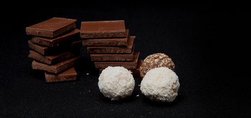 Stack of Black and White Chocolate isolated on black background, top view with copyspace for your text