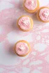 top view vanilla cupcakes with pink frosting