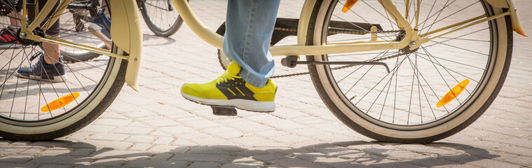 Closeup of cyclist man legs riding bike on outdoor trail in nature