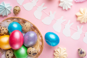 Easter holiday background. Easter eggs colored with rabbit ears on a pink background, horizontal composition. Greeting card concept