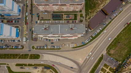 Top down view of buildings, street roads with cars in Krasnodar city, Russia