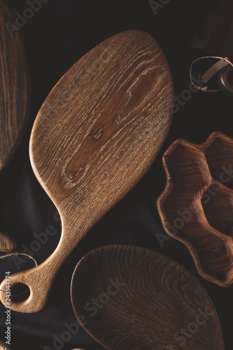 Kitchen Set Brown Oak Tableware set of cutting boards and diy kitchen wooden utensils plates and dishes made from oak walnut and pine wood isolated on dark background