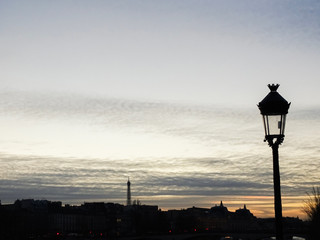 A lamp post at sunset in the city of Paris