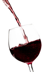 Obraz na płótnie Canvas Beautiful splash of red wine in a glass on white background.