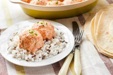 Chicken meatballs in creamy tomato sauce with rice