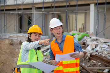 Engineer manager inspects construction sites and checking blueprints at building townhome project