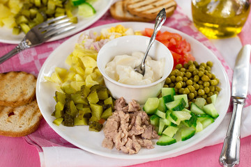 Cobb style salad with diced vegetables and canned cod liver