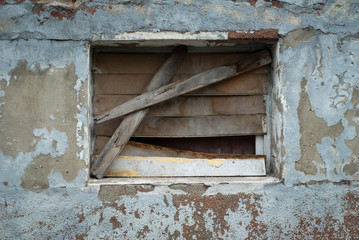 Abandoned building, ruins, broken window, window clogged, rust, unfinished