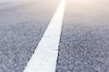 Closeup photo of the road with white line