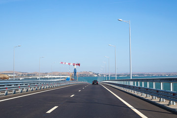 the car rides on the bridge