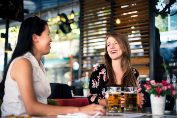 Female friends having a talk in the coffee bar