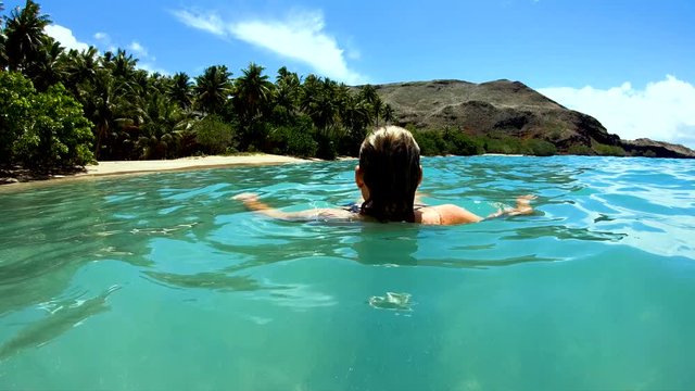 Female on a deserted Island beach Tahuata Marquesas