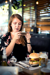 Woman taking photo of food at the restaurant