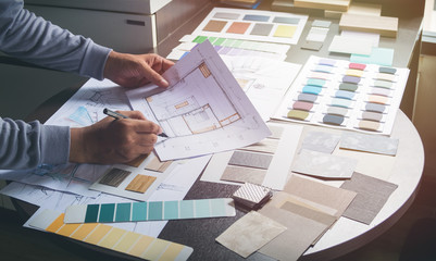 Architect designer Interior creative working hand drawing sketch plan blue print selection material...