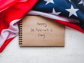 St.Patrick 's Day. Beautiful card. Sketchbook with congratulatory inscription. Isolated background, closeup, top view, wooden surface. Congratulations for loved ones, relatives, friends and colleagues