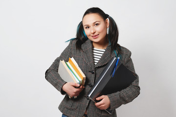 Portrait of young student woman holding books and folders