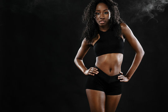 Sporty Fit Black Skin Woman, Athlete Makes Fitness Exercising On Dark Background.