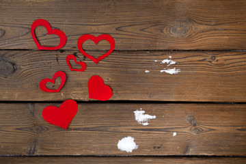 Red paper Valentine hearts on wooden background. Valentine's day gift.