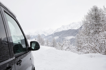 Fototapeta na wymiar Driving on a snowy mountain roadd
