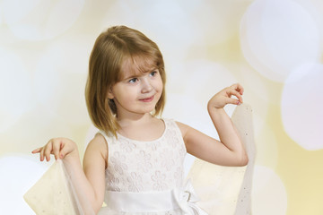 Beautiful happy little girl in white dress