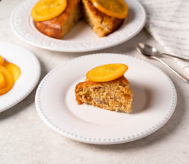 a slice of cake with sugar orange on top