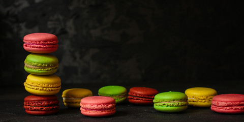macaron or macaroon cake, colorful cookies (dark background). copy space