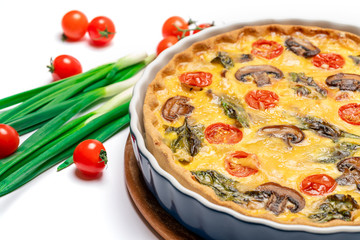 Baked homemade quiche pie in ceramic baking form on concrete background