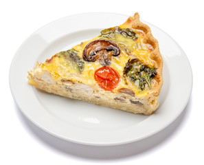 Slice of traditonal homemade spinach chicken quiche tart or pie on plate