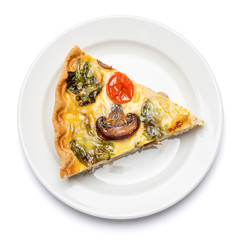 Slice of traditonal homemade spinach chicken quiche tart or pie on plate