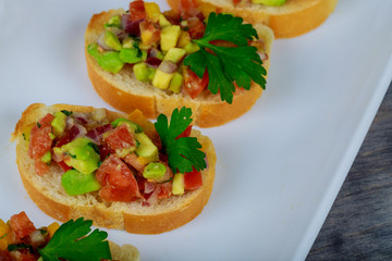 sandwich with avocado and salmon on a green onions and bread and tomatoes. sandwich healthy fast food