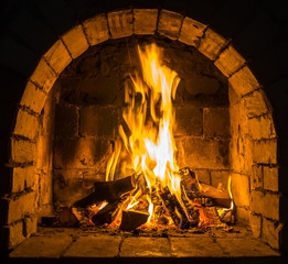 Wood burning in a cozy fireplace at home, keep warm