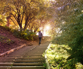 man climbing the stairs in the park