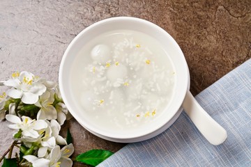 Tapioca pudding and glutinous rice ball sweetmeats in a white bowl