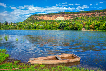 natural landscape with old wooden boat on the river shore