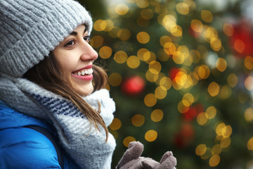 closeup horizontal image of a s happy smiling woman in warm winter clothes against the background...