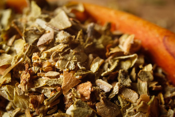 Dried oregano spice in a spoon. Extreme macro photography.