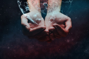 Human forefinger touches atom. Nebula dust  in infinite space. Mixed media.