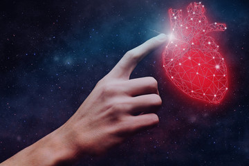 Human forefinger touches blue heart innovative technologies. Nebula dust  in infinite space. Mixed...