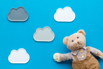 Craft toys for kids. Handmade teddy bear. Blue background top view