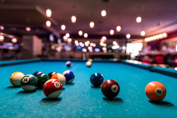 Colorful billiard balls on playing table, dispersed