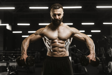 Naklejka na ściany i meble Handsome strong athletic men pumping up muscles workout bodybuilding concept background