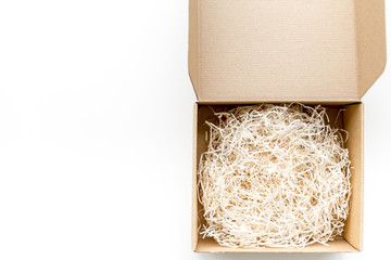 E-commerce. Delivery of goods that was purchased online. Empty cardboard box with cut paper on white background top view copy space