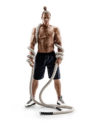 Athletic strong man with heavy ropes in hands. Photo of muscular male with naked torso isolated on white background. Full length