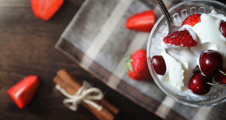 Fresh yogurt with berries. Ice cream in a bowl with fresh and juicy strawberries and cherries. Dessert with red berries.