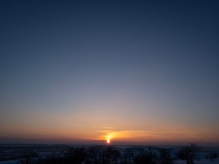sunset over the field and blue sky