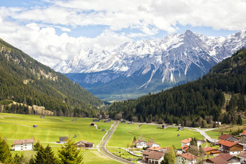 Beautiful alp meadows with stellar views on the hills and snowcapped mountains near Lähn, Tirol, Austria.