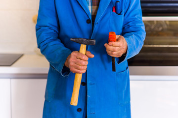 Uniform handyman working in the kitchen