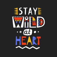 Lettering poster Stay Wild At Heart made of letters of cutout ethnic styles on a black background