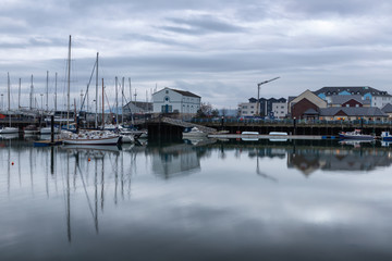 Fototapeta na wymiar Carrickfergus Harbour with boats and reflection